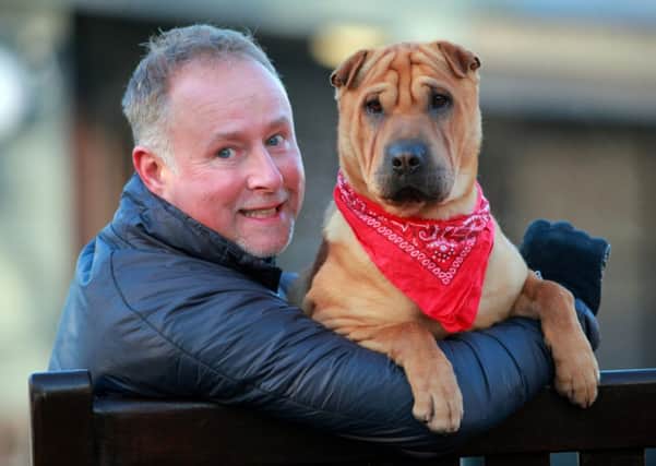Kai the dog meets his new owner Ian Russell. Picture: Hemedia