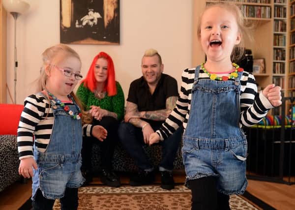 Tracii and Neil Smith with their twin daughters Ruby, who has Downs syndrome, and Darby. Picture: Neil Hanna