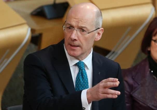 John Swinney has threatened to cut Labour councils' funding if they don't protect teacher numbers. Picture: PA