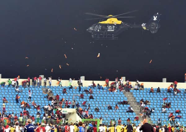 A police helicopter hovers over the stadium in Malabo with the match suspended. Picture: Getty