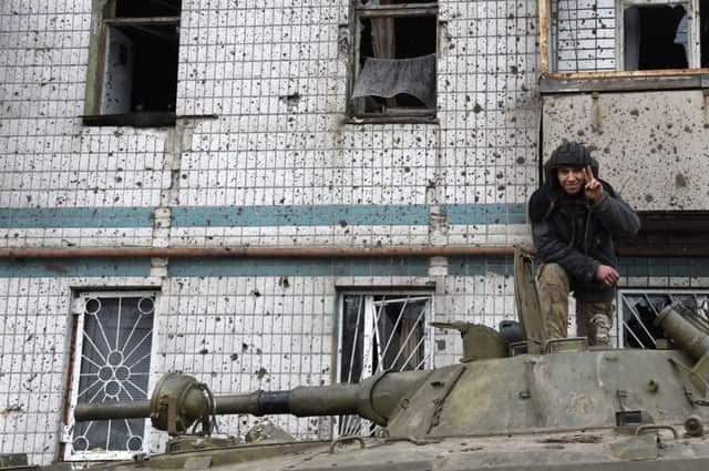 A rebel flashes a victory sign as he stands on a tank at Donetsk airport. Picture: Getty