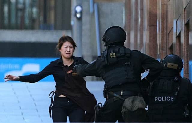 Bae Jie-un says she 'really dislikes' iconic image of her escape from Sydney café siege. Picture: AP