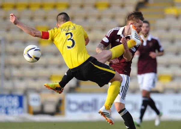 Sam Nicholson is caught by Jason Talbot in the first half of Saturday's clash. Picture: Ian Rutherford