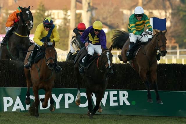 Carlingford Lough, right, clears the last fence on his way to victory yesterday. Picture: PA