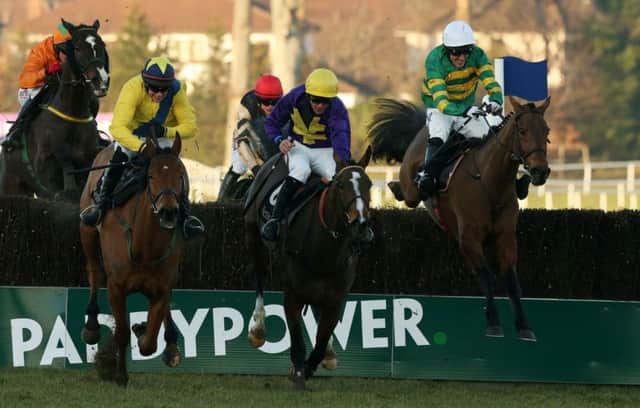 Carlingford Lough, right, clears the last fence on his way to victory yesterday. Picture: PA