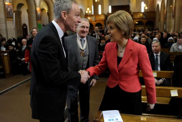 A rare hand shake between political rivals First Minister of Scotland Nicola Sturgeon and Jim Murphy. Picture: SWNS