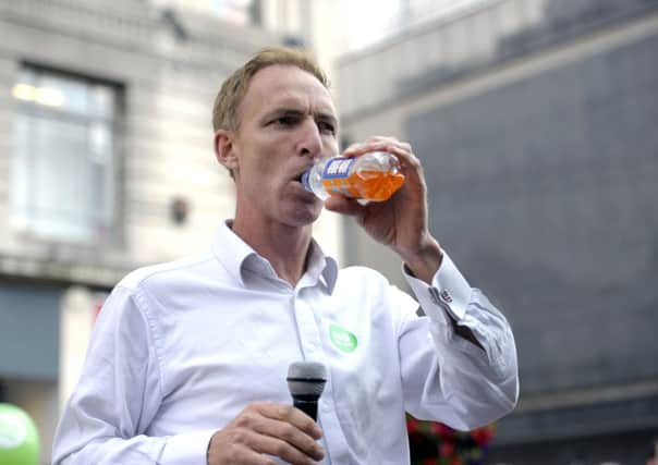 Jim Murphy takes a swig of Irn-Bru during his 100 Towns tour. Picture: John Devlin