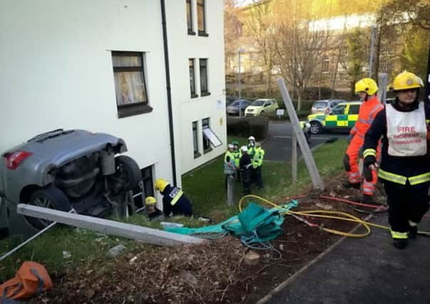 The driver had a lucky escape after the car ended up wedged between a house and a wall. Picture: Hemedia