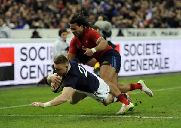 Scotland's Dougie Fife (left) dives in to score a try in Paris. Picture: PA