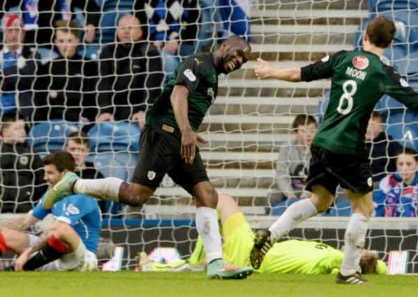 Christian Nade wheels away after scoring the winner at Ibrox. Picture: SNS