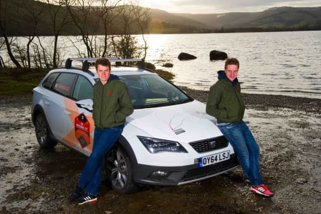 Alistair, left, and Jonny Brownlee with the SEAT car they raced against during winter training. Picture: PA
