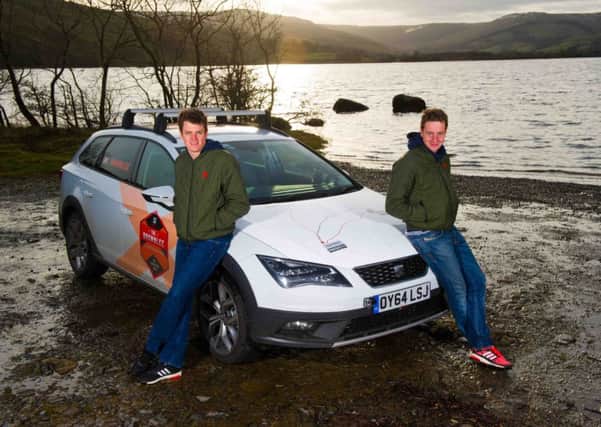 Alistair, left, and Jonny Brownlee with the SEAT car they raced against during winter training. Picture: PA