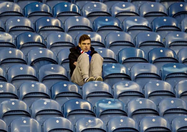 A solitary Rangers supporter takes in the aftermath of the Scottish Cup defeat to Raith. Picture: SNS
