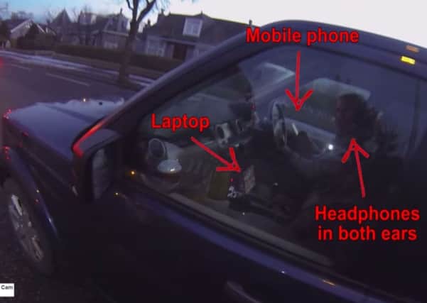 YouTube of footage by Aberdeen Cycle Cam apparently showing a motorist driving while using a mobile phone, laptop and earphones. Picture: PA