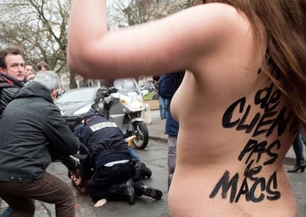 Police detain topless Femen activists outside the court. Picture: Denis Charlet/Getty