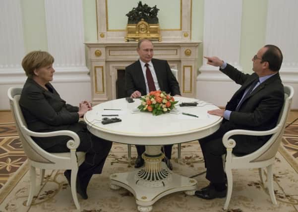 French President Francois Hollande, Russian President Vladimir Putin, center, and German Chancellor Angela Merkel meet for talks on Ukraine. Picture: AP