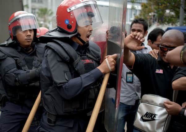 Supporters of opposition leader Anwar Ibrahim are corralled by riot police outside the court. Picture: Getty
