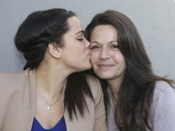 Sophie Serrano, right, is kissed by her daughter Manon. Picture: AP
