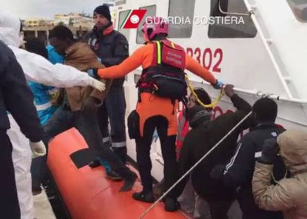 Migrants disembark from a boat from the Italian coast guards after a rescue operation off the coast of Lampedusa on Tuesday. Picture: Getty