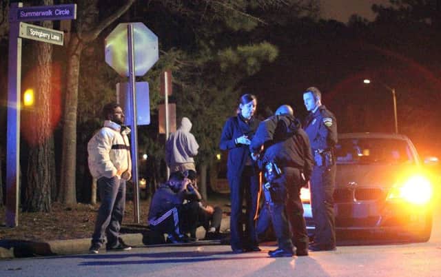 Chapel Hill police officers investigate the scene of three murders near Summerwalk Circle. Picture: