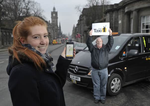 Student Lara Magyar shows off the new app with cabbie David Sutherland. Picture: Ian Rutherford
