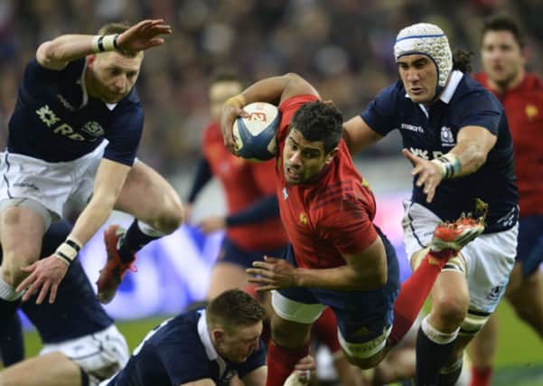 Wesley Fofana falls next to Scotland's flanker Blair Cowan and Scotland's fly-half Finn Russell. Picture: Getty