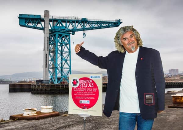 A Comic Relief statue of Billy Connolly in front of the famous Titan Crane at the site of the former John Browns Shipyard in Clydebank, Scotland. Picture: Young Media