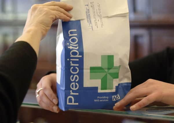 A prescription is handed over at a pharmacy. Picture: Ian Rutherford