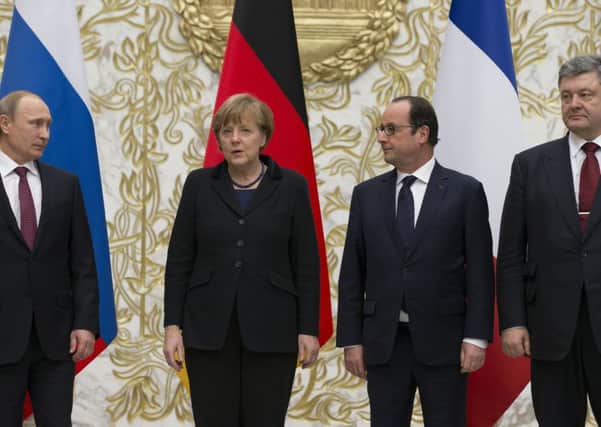 Vladimir Putin, Angela Merkel, Francois Hollande and Petro Poroshenko at the peace talks in Minsk, Belarus. Picture: AP