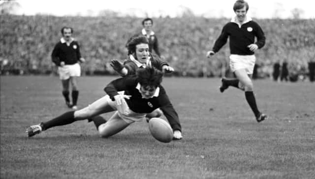 Scotland full-back Andy Irvine thwarts his opposite number JPR Williams