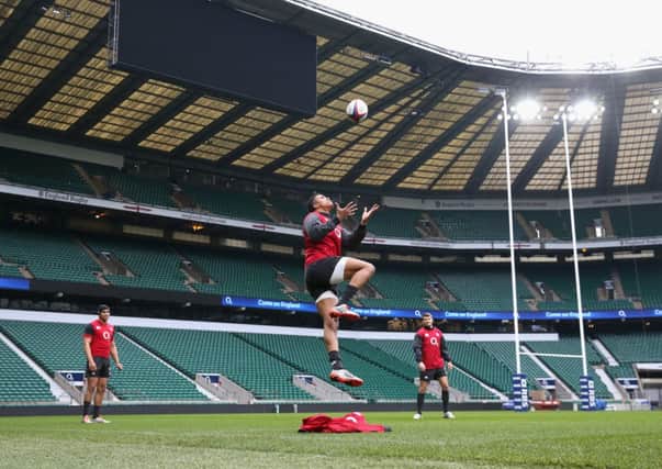 Anthony Watson, centre, catches the ball during an England training session yesterday. Picture: Getty