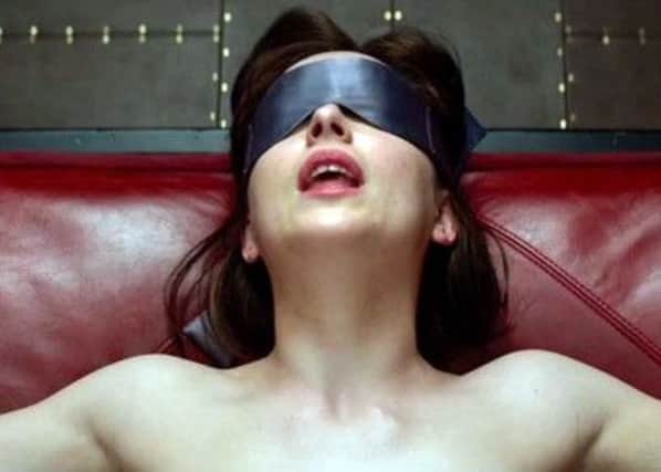 All tied up: Dakota Johnson costars in the film of EL Jamess Fifty Shades of Grey. Picture: Getty