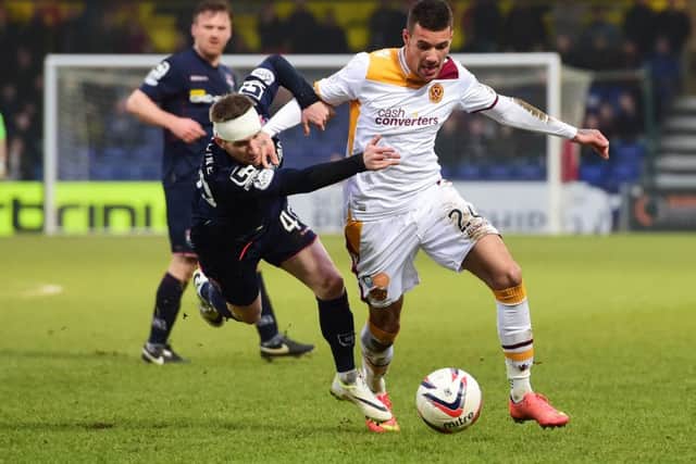 Motherwell's Marvin Johnson, right, holds off Michael Gardyne. Picture: SNS