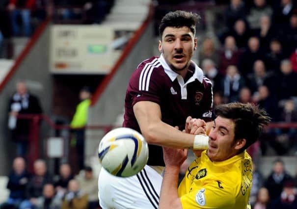 Hearts full-back Callum Paterson outjumps Livingston defender Declan Gallagher. Picture: Lisa Ferguson