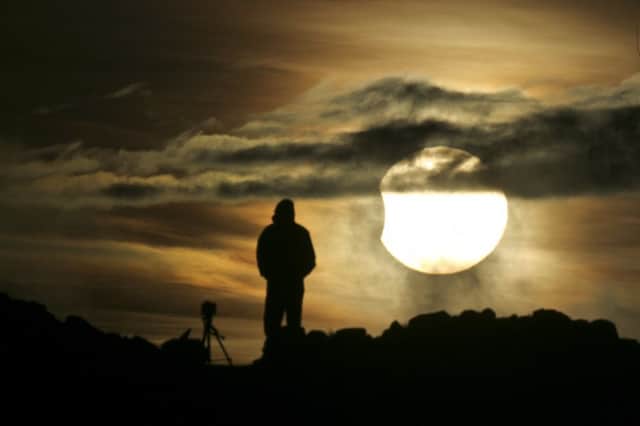 A solar eclipse as viewed from the summit Arthurs Seat. Picture: Toby Williams