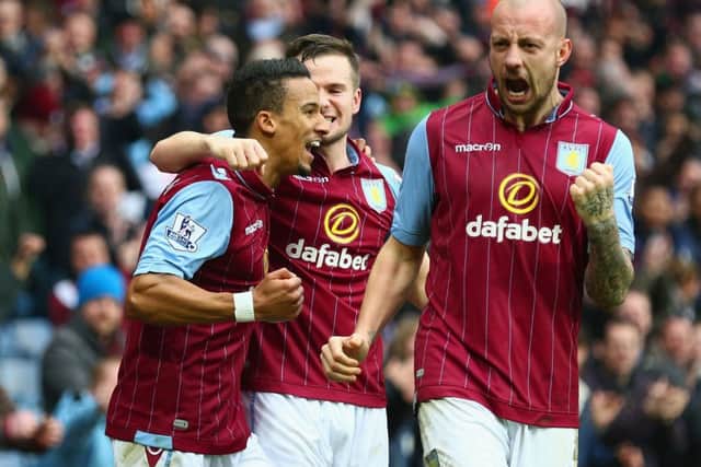 Scott Sinclair, left, celebrates scoring Villas second goal with Tom Cleverley and Alan Hutton. Picture: Getty