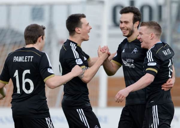 Andrew Considine is congratulated by teammates after opening the scoring. Picture: SNS