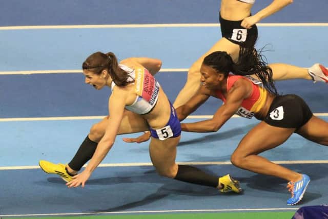 Seren Bundy-Davies and Margaret Adeoye crash out of a dramatic womens 400m final. Picture: PA