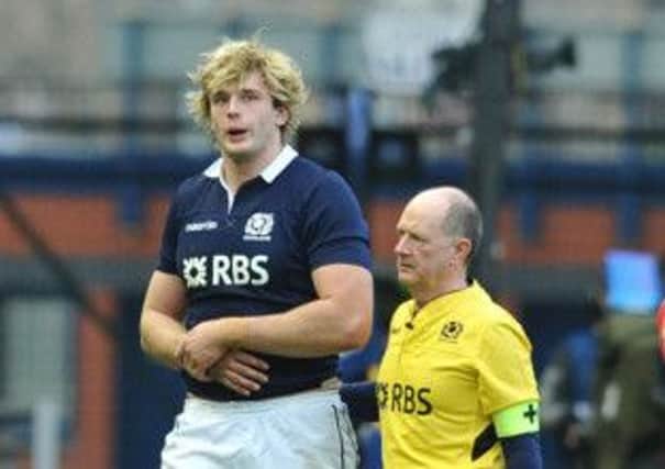 Richie Gray is led from the field by doctor James Robson during Sundays match. Picture: Ian Rutherford