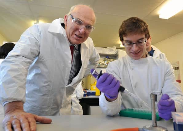 Vince Cable with apprentice John Devlin on a visit to Ingenza ltd, BioCentre in Midlothian yesterday. Picture: Ian Rutherford