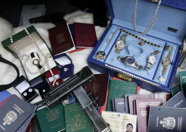 Items confiscated by police as a result of fraud. Instances of fraud have risen by 67 per cent in Scotland in the past year. Picture: PA