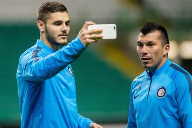 Inter Milan striker Mauro Icardi, left, takes a photo as and Gary Medel train at Celtic Park. Picture: SNS