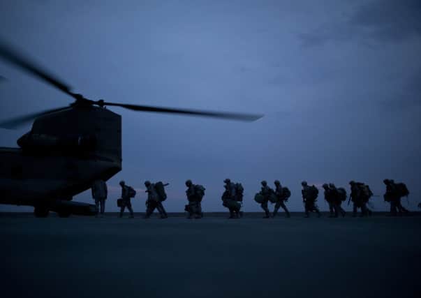 FILE -- Soldiers board a transport helicopter departing from a military base in Kunduz, Afghanistan, March 6, 2011. Even as the Talibanâ¬"s rule spreads across the northern province of Kunduz, Western officials insist that the Afghan security forces have managed to contain the insurgentsâ¬" offensives on their own and have made no efforts to send in the cavalry. (Damon Winter/The New York Times)