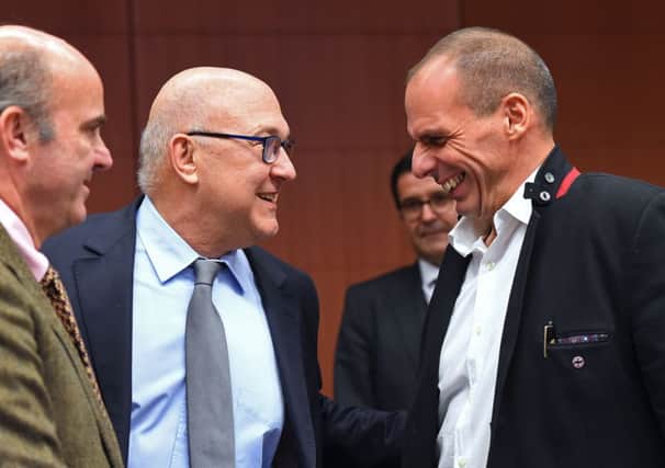 Yanis Varoufakis, right, with his counterparts Luis de Guindos Jurado, left, and Michel Sapin. Picture: Getty