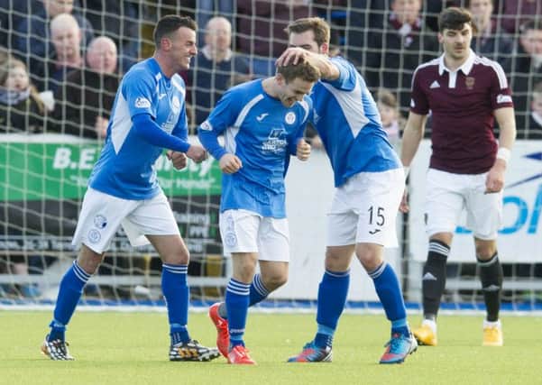Queen of the South's Daniel Carmichael (centre) celebrates with team-mate Michael Paton (right). Picture: SNS Group