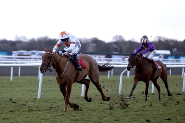 AP McCoy steers Ghost River, left, to victory in the racinguk.com Standard Open National Hunt Flat. Picture: PA