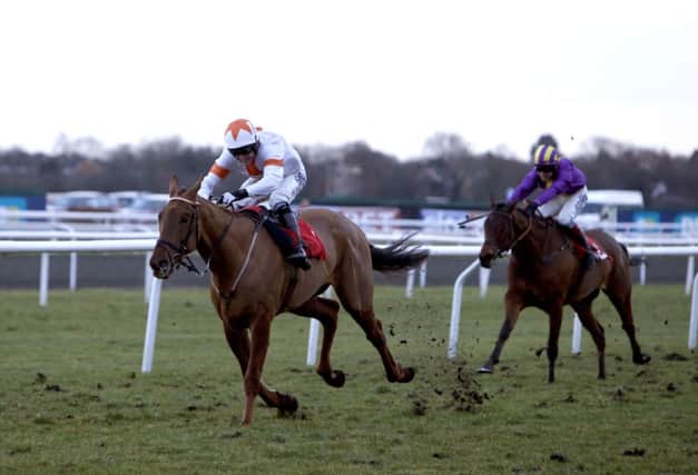 AP McCoy steers Ghost River, left, to victory in the racinguk.com Standard Open National Hunt Flat. Picture: PA