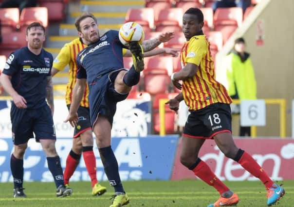 Ross County's Martin Woods battles for posession of the ball with Abdul Osman (right). Picture: SNS Group