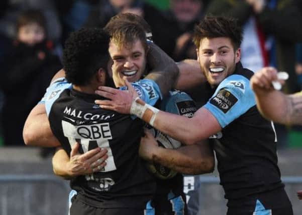 Pat MacArthur, centre, is all smiles after bagging his first try for Glasgow. Picture: SNS