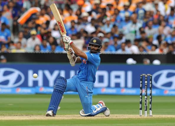 India batsman Shikhar Dhawan hits out on his way to a century in a one-sided contest at the MCG. Picture: AFP/Getty